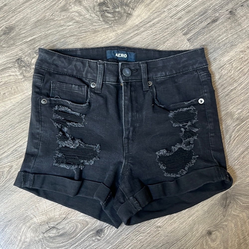 Aero black distressed high rise midi shorts.